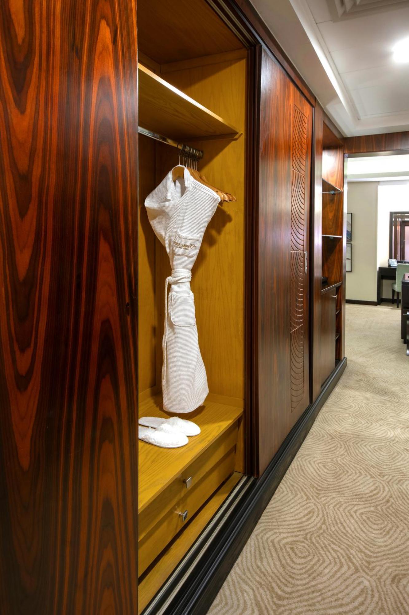 Triumph Luxury Hotel Cairo Room photo A bathrobe hanging in a closet